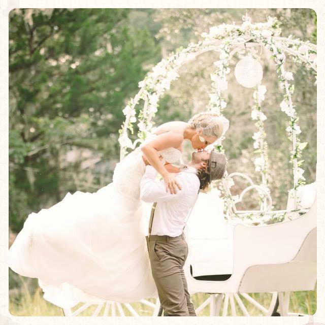 Pretty picture of one of our bride and grooms kissing in front of our Cinderella carriage in St. Mary's, Georgia.